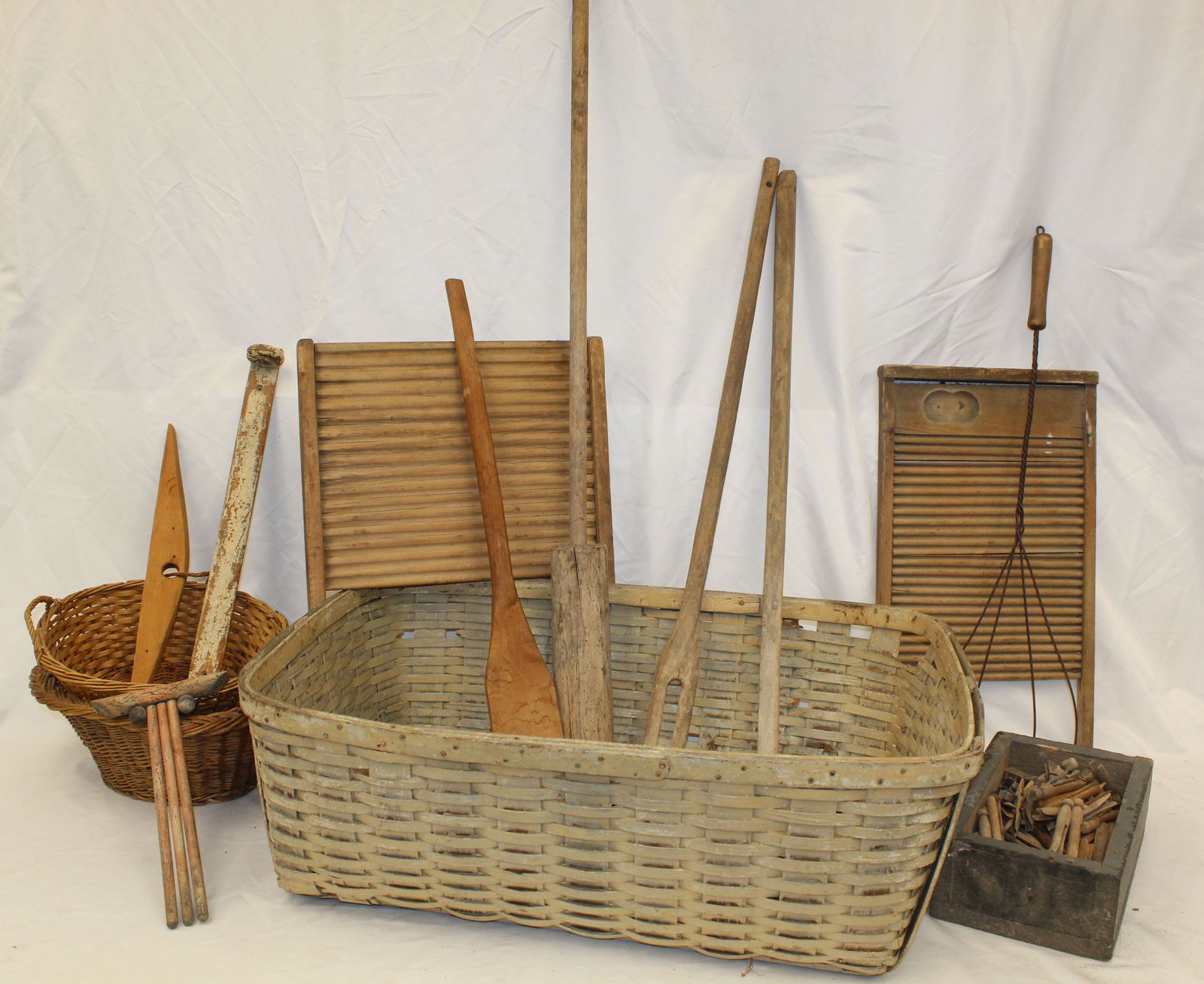 Antique laundry basket filled with laundry related items incl long handled paddles, wash board, (1 of 7)
