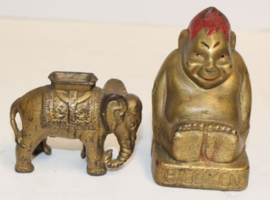 Lot of 2 antique cast iron still banks in gold paint incl elephant & Billiken - 2 1/2" & 3 1/2" tall