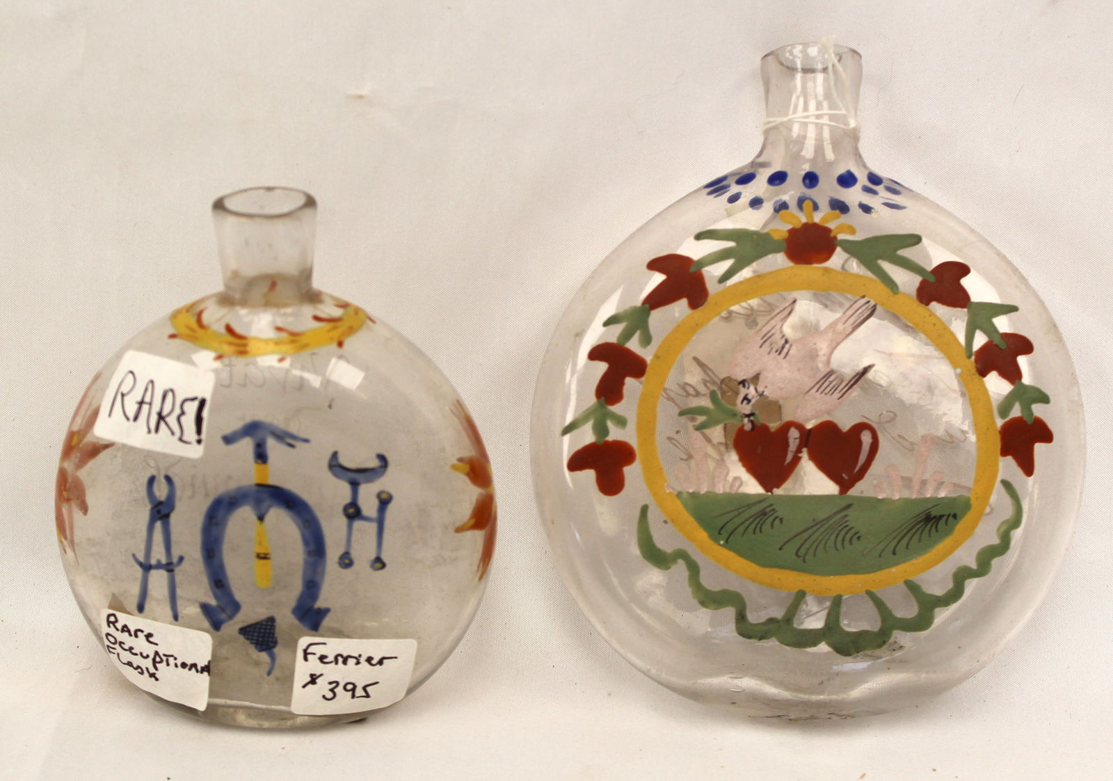 Lot of 2 early paint decorated clear glass flasks - incl a Ferrier occupational example & the other (1 of 14)