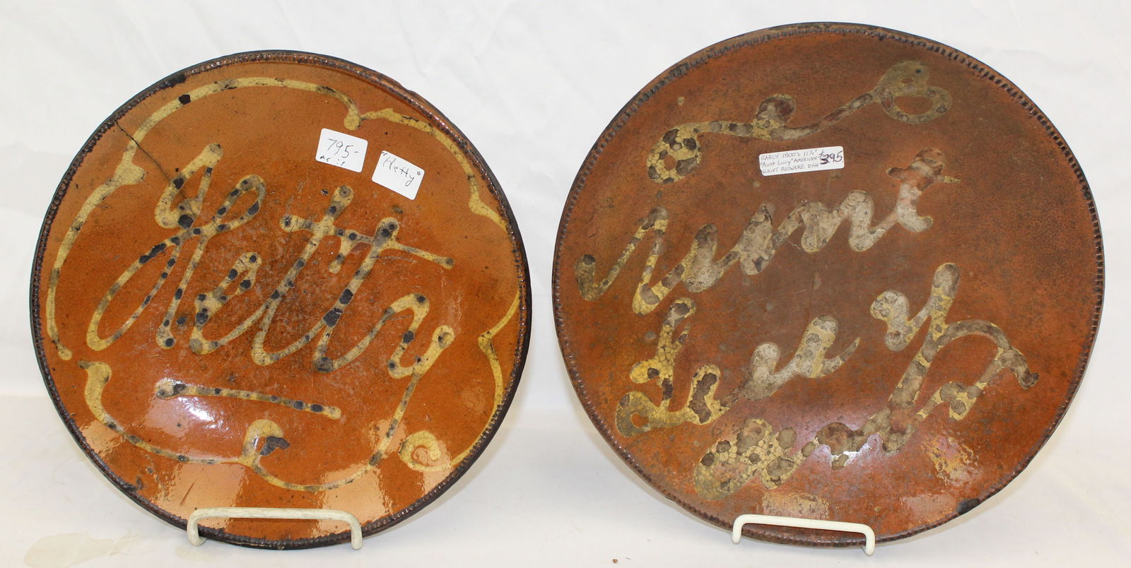 Lot of 2 antique redware plates w slip decoration - "Hetty" & "Aunt Lucy" - 10" & 11 1/4" diam: Lot of 2 antique redware plates w slip decoration - "Hetty" & "Aunt Lucy" - 10" & 11 1/4" diam