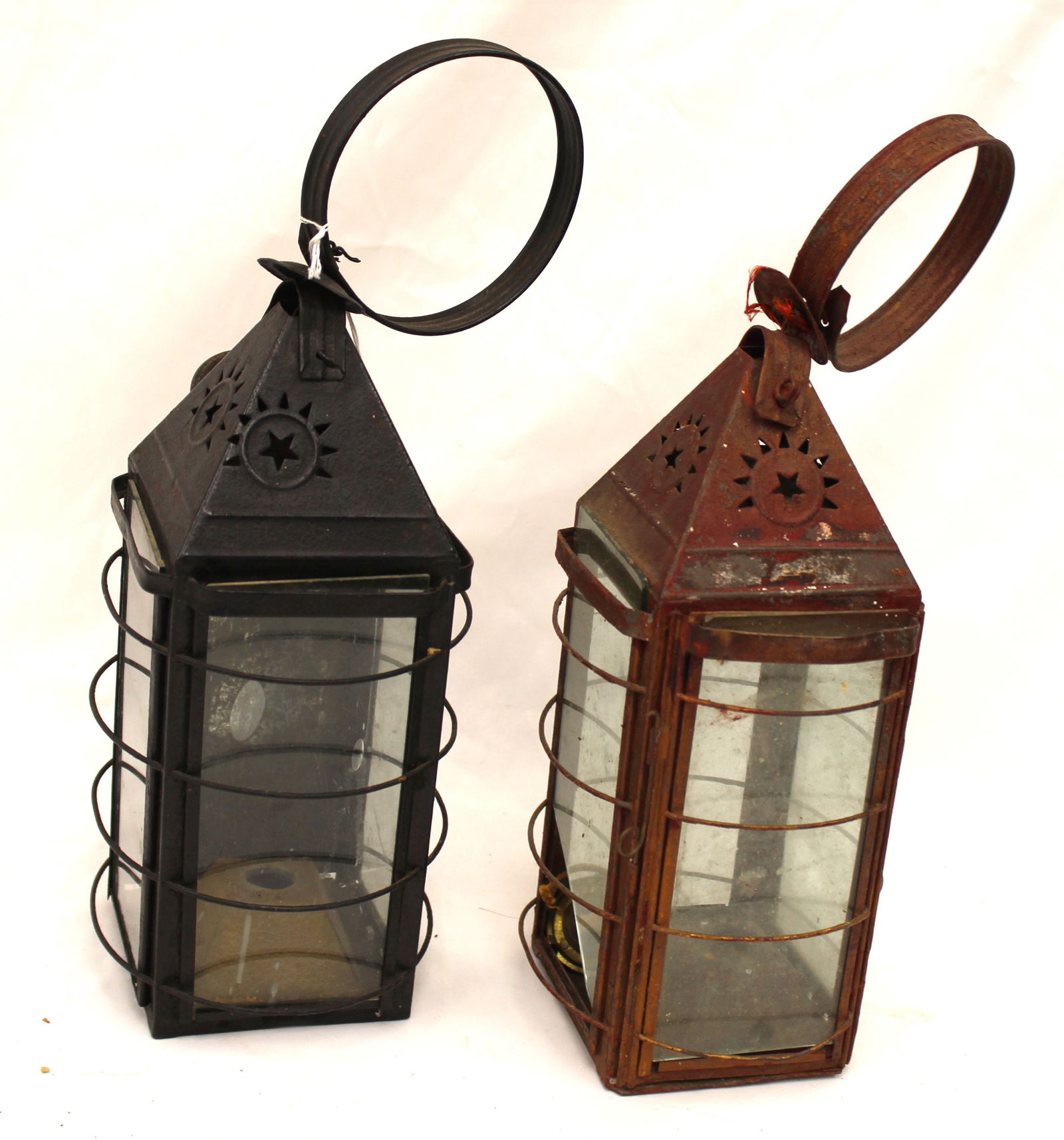 Lot of 2 punched tin & glass lanterns in red & black paint - 14" & 15" tall: Lot of 2 punched tin & glass lanterns in red & black paint - 14" & 15" tall