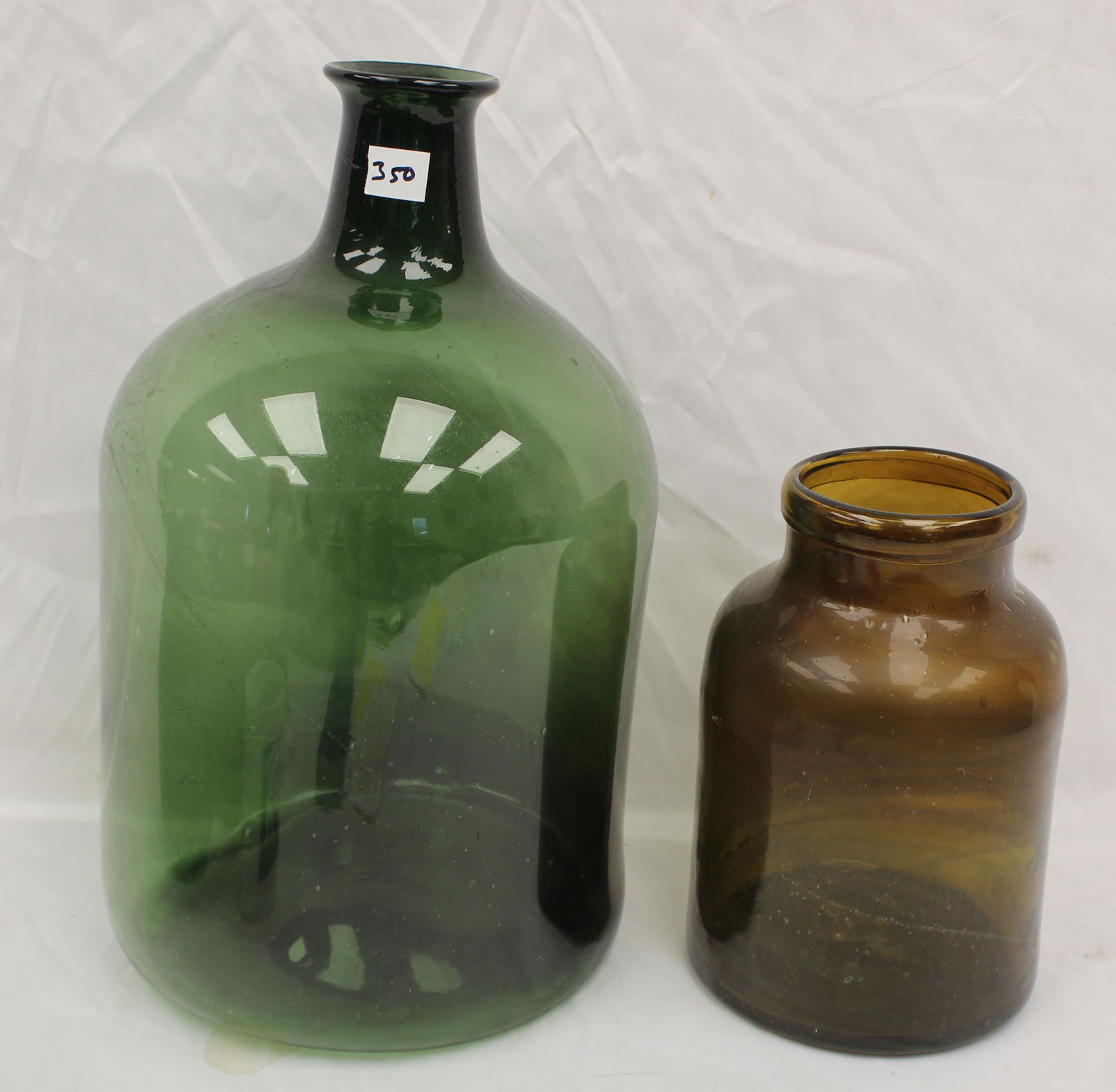 Lot of 2 early glass large vessels - 16 1/4" bottle in green & 9 1/2" jar in amber: Lot of 2 early glass large vessels - 16 1/4" bottle in green & 9 1/2" jar in amber