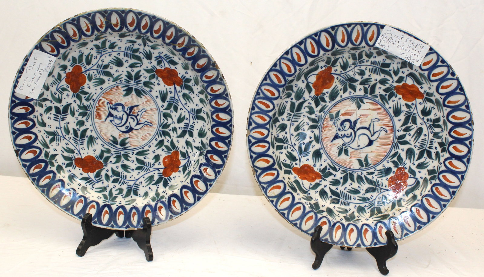 Pair of Delft chargers w cherub motif - 13 3/4" diam: Pair of Delft chargers w cherub motif - 13 3/4" diam