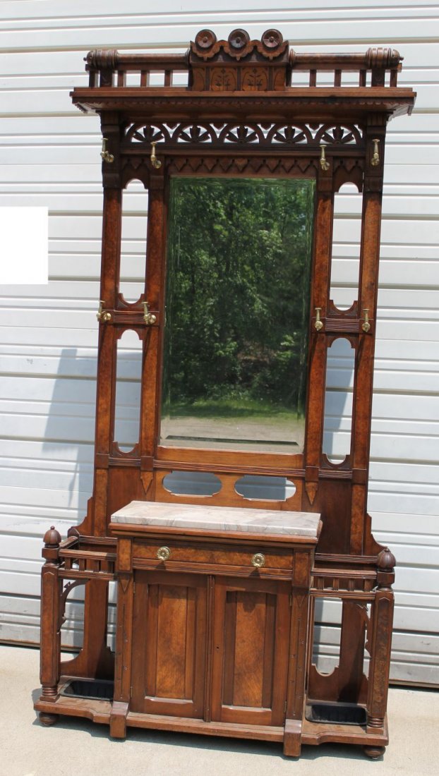 exceptional and large American carved walnut ca 1870: exceptional and large American carved walnut ca 1870 Victorian Renaissance Revival hall tree w brass hooks, glove drawer & beveled mirror - surmounted w fancy carved cornice & crest - 7'3" tall x 3'6"