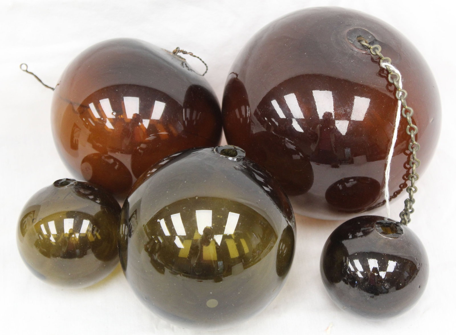Lot of 5 early glass witch's balls in amber & green - 2 1/2" - 5" diam: Lot of 5 early glass witch's balls in amber & green - 2 1/2" - 5" diam