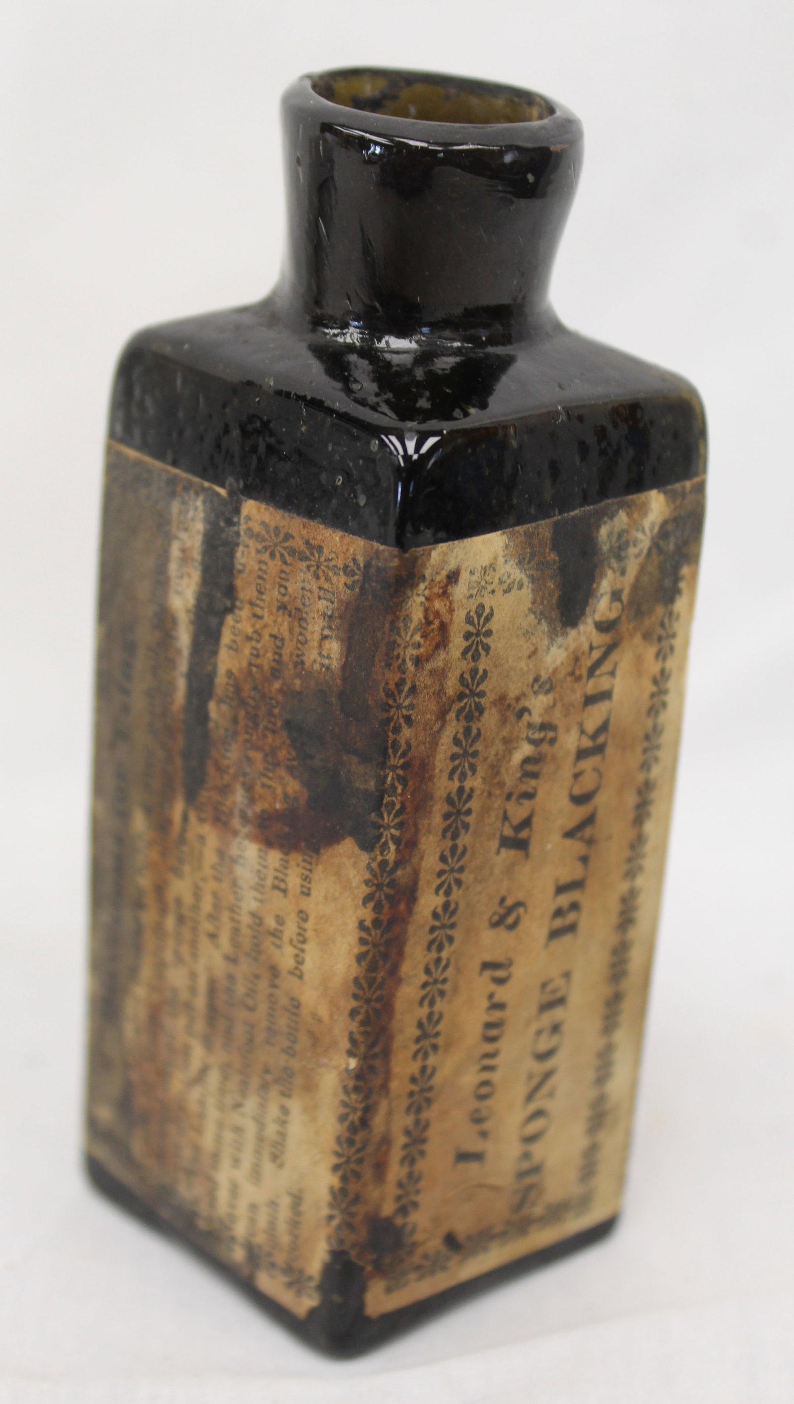 Early dark green/black glass bottle w orig label - 4 1/2" tall: Early dark green/black glass bottle w orig label - 4 1/2" tall