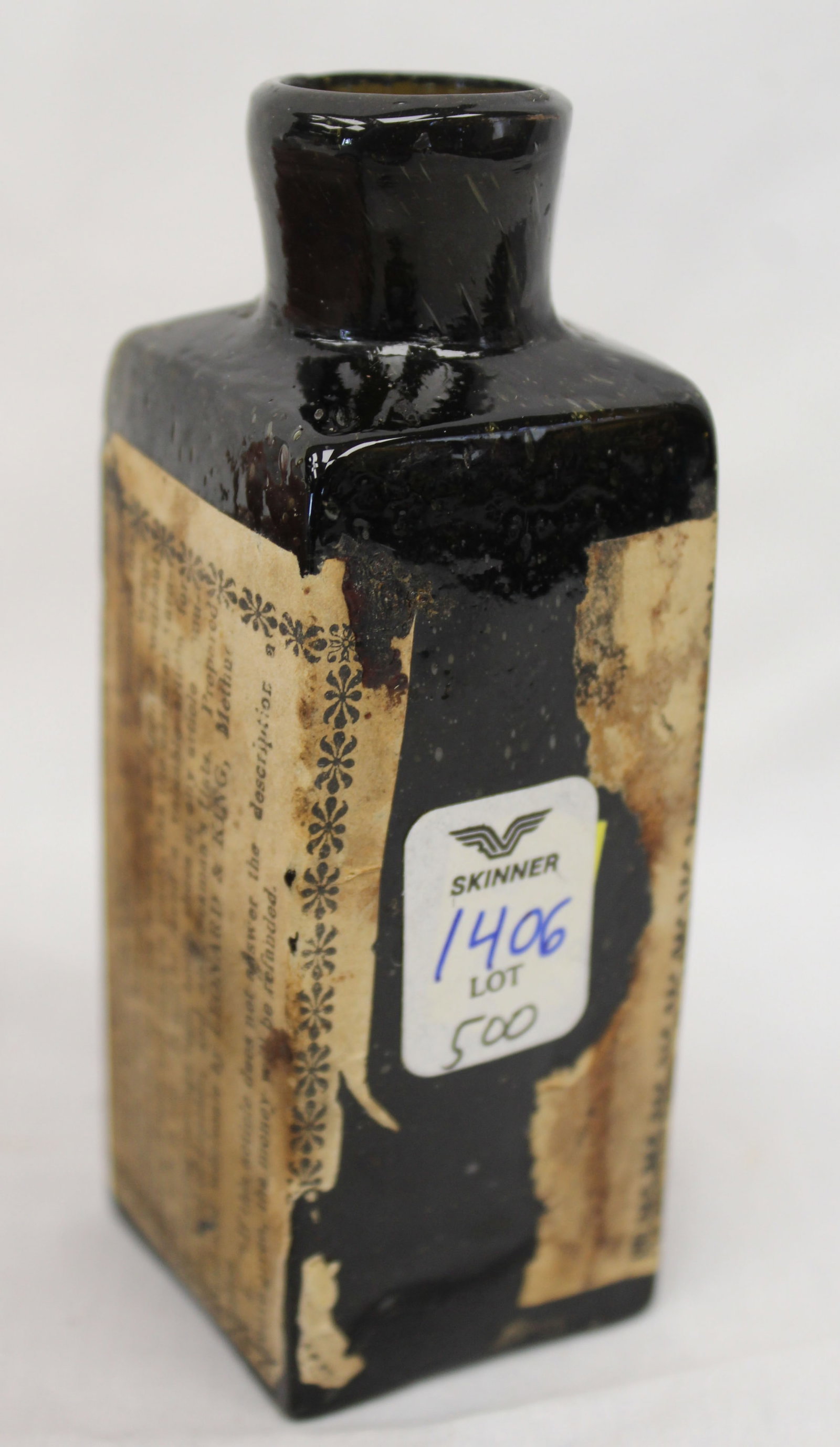 Early dark green/black glass bottle w orig label - 4 1/2" tall - 4