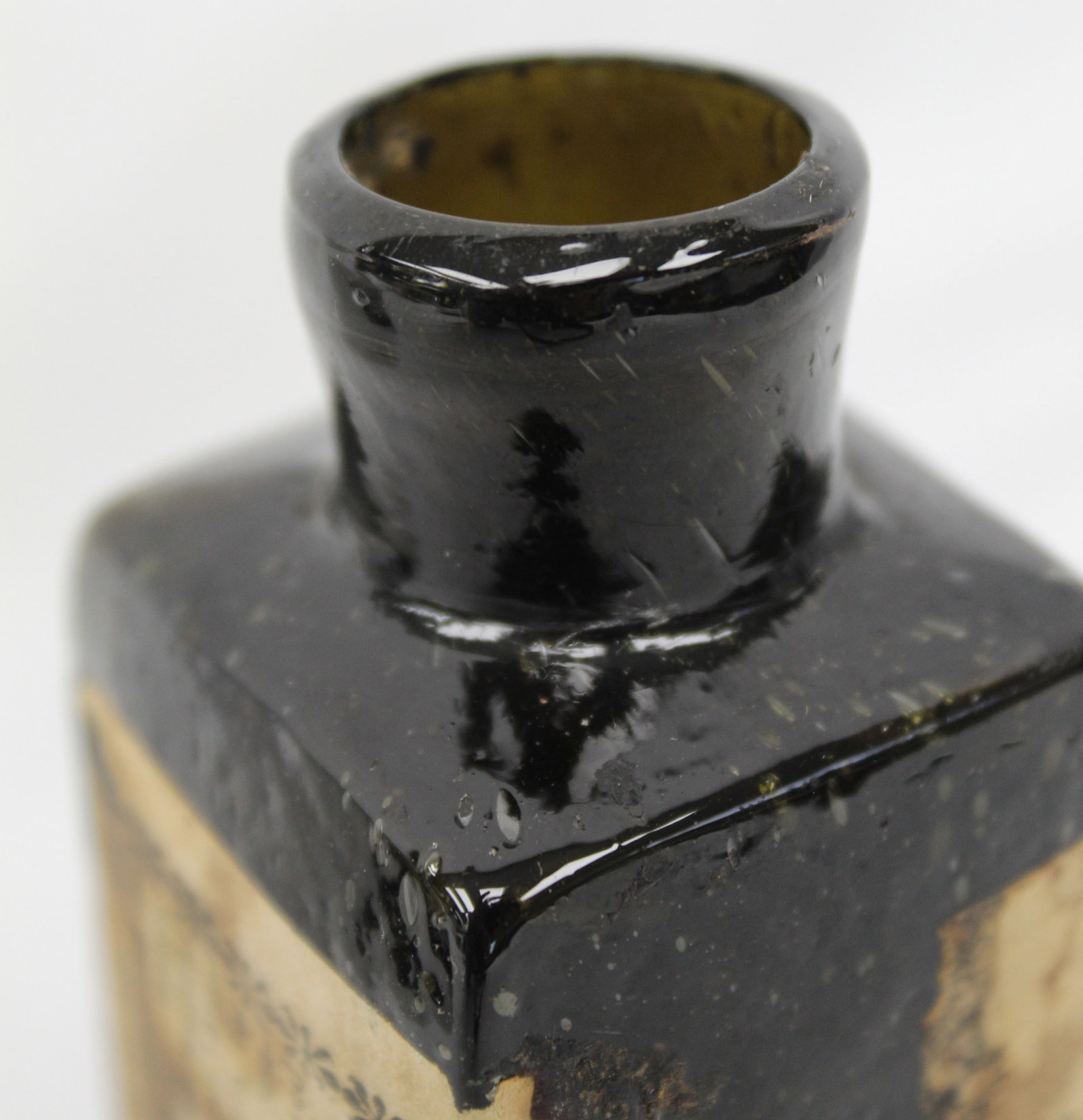 Early dark green/black glass bottle w orig label - 4 1/2" tall - 5