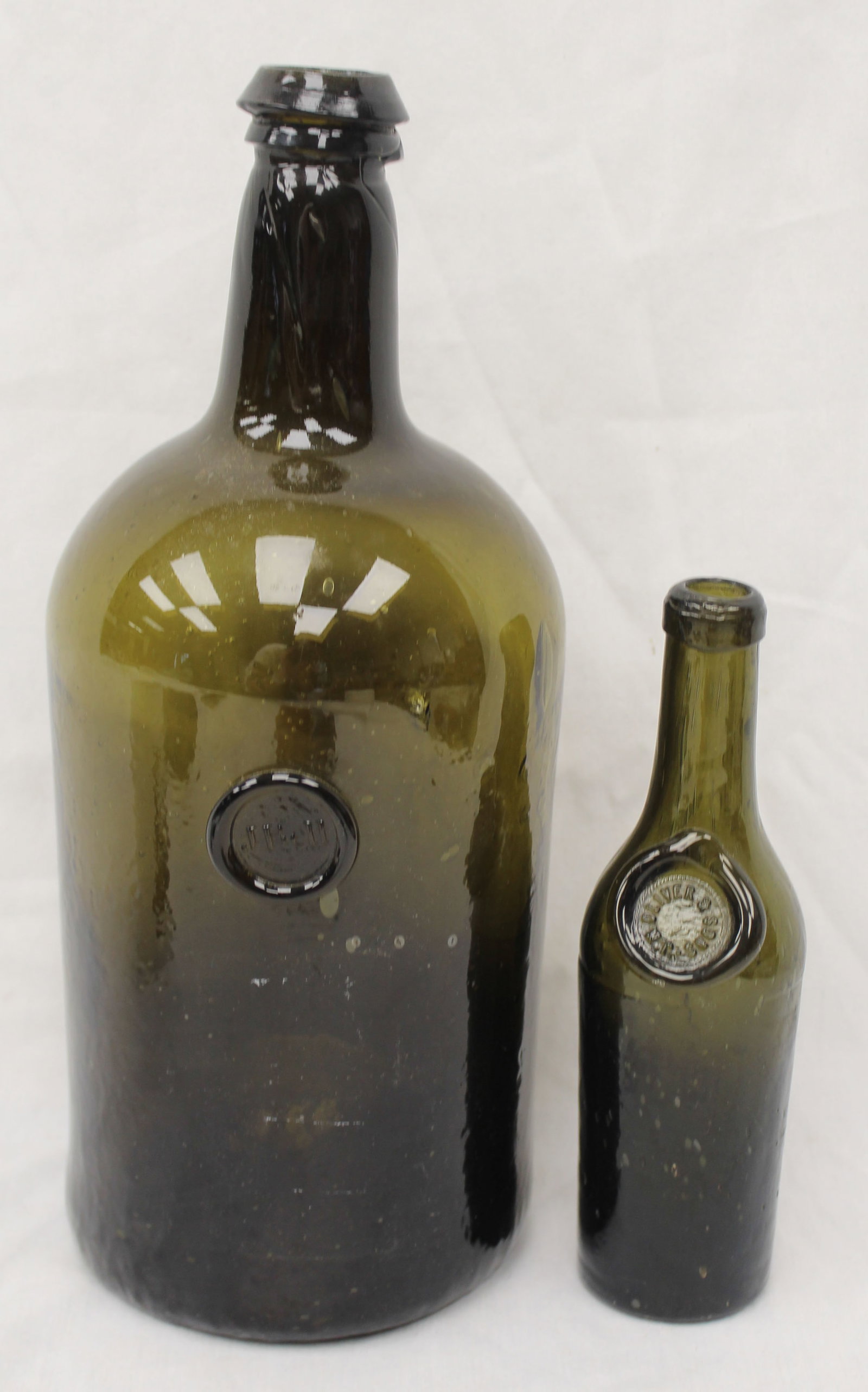 Lot of 2 early dark green glass bottles w seals - 7" & 11 1/2" tall (1 of 8)