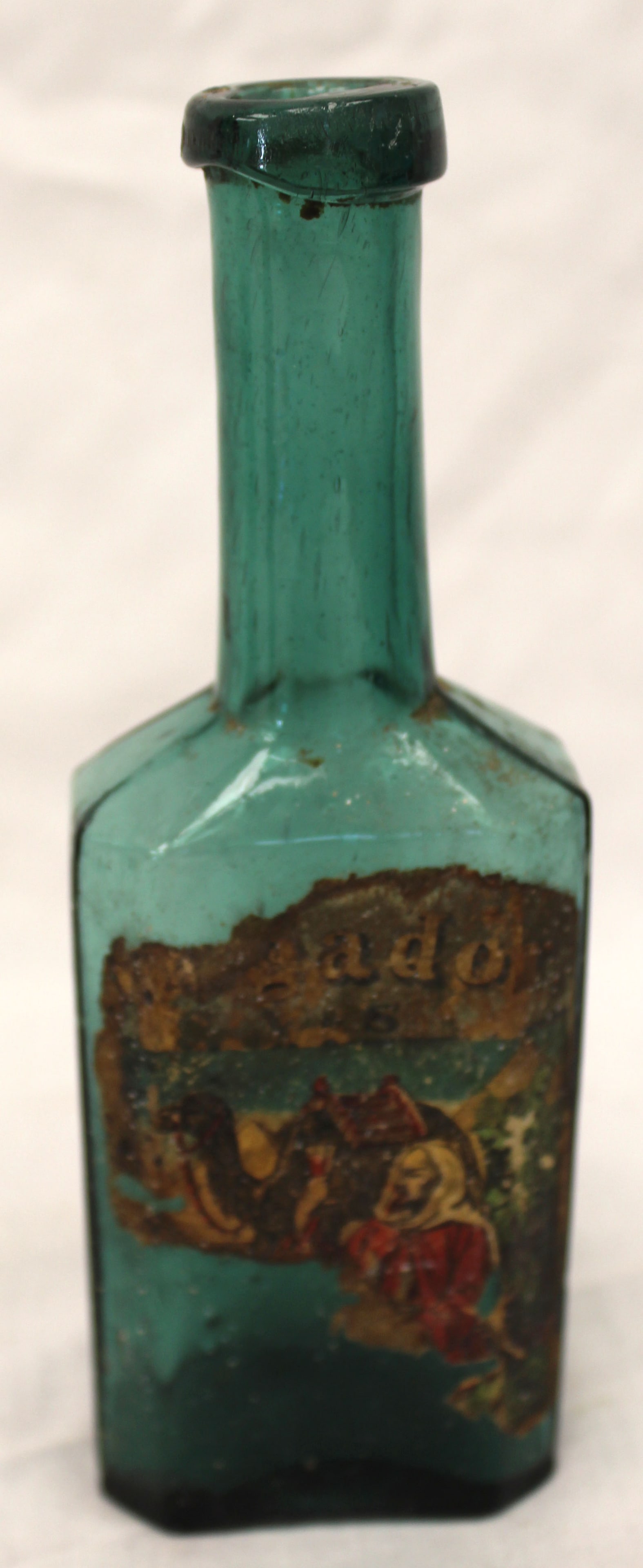 Early green glass bottle w remnants of orig label - 6 1/2" tall: Early green glass bottle w remnants of orig label - 6 1/2" tall