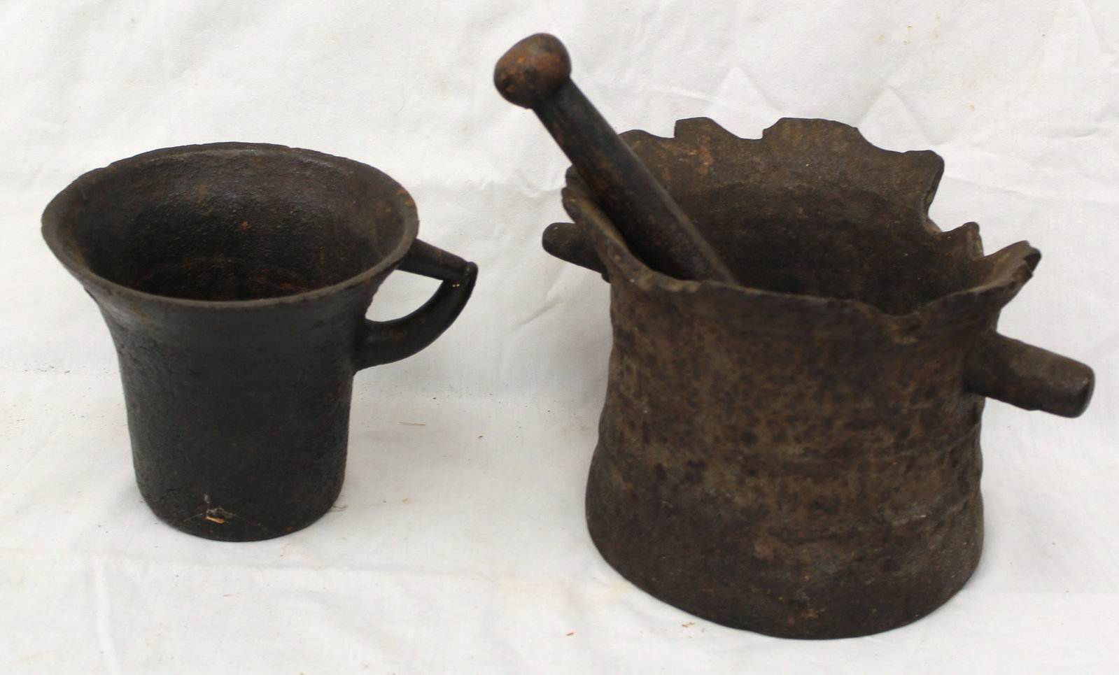 Very early cast iron mortar & pestle plus another cast iron mortar - 6" tall x 7" diam & 9" pestle & (1 of 4)