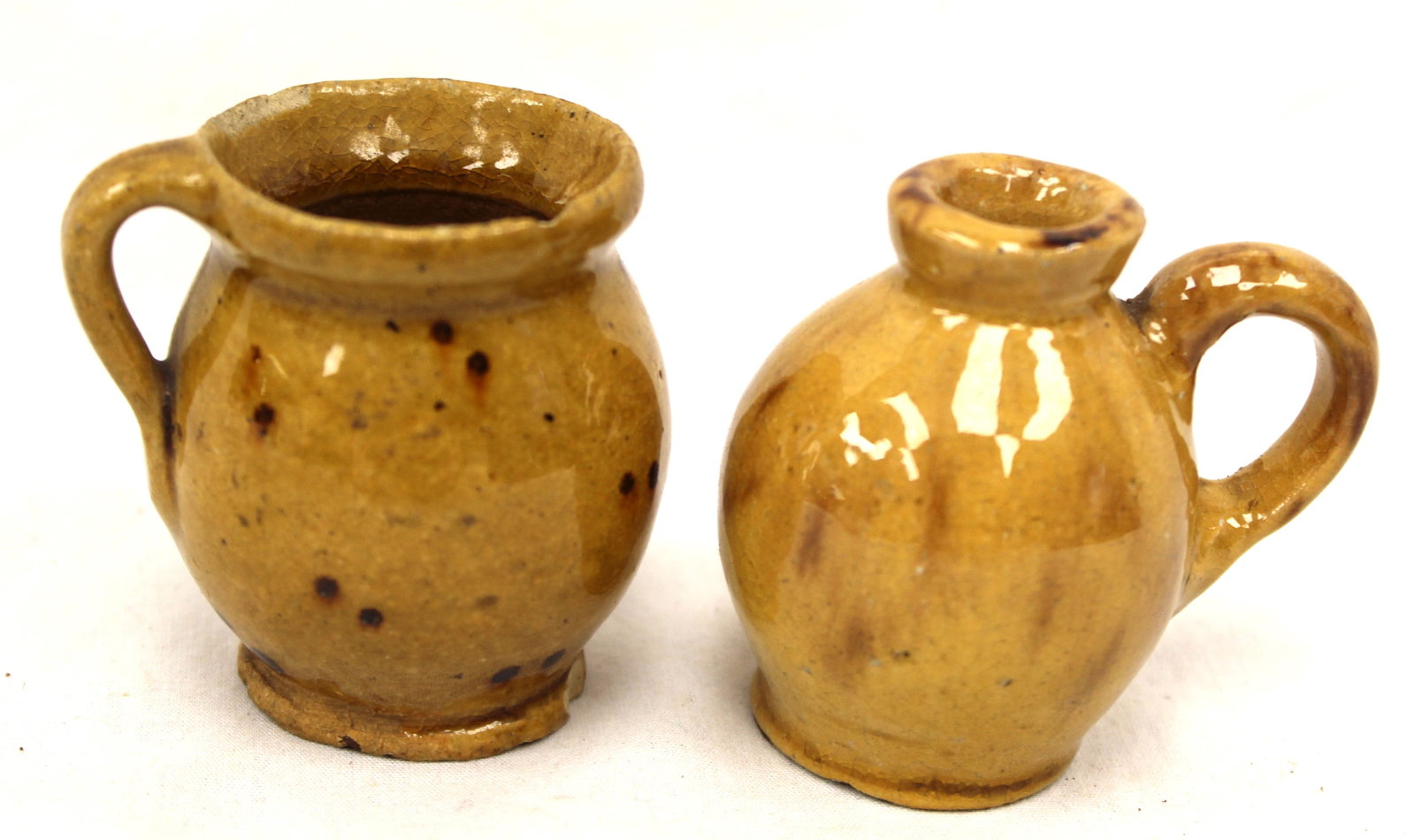 Lot of 2 miniature earthenware yellow glaze pitchers - 2" tall (1 of 9)
