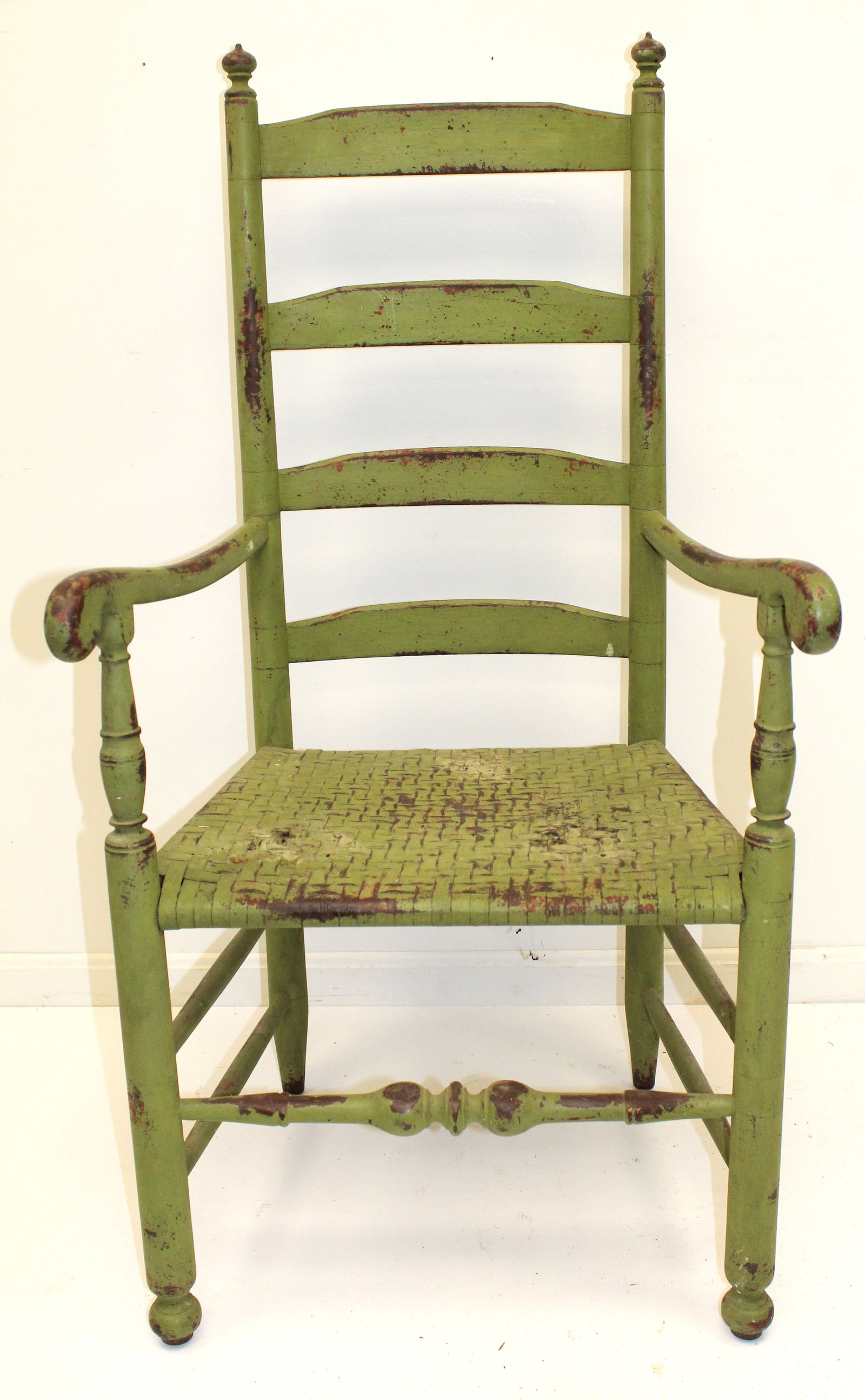 Antique ladderback armchair in green paint w splint seat - 45" tall x 23"wide x 20" deep w 18" seat