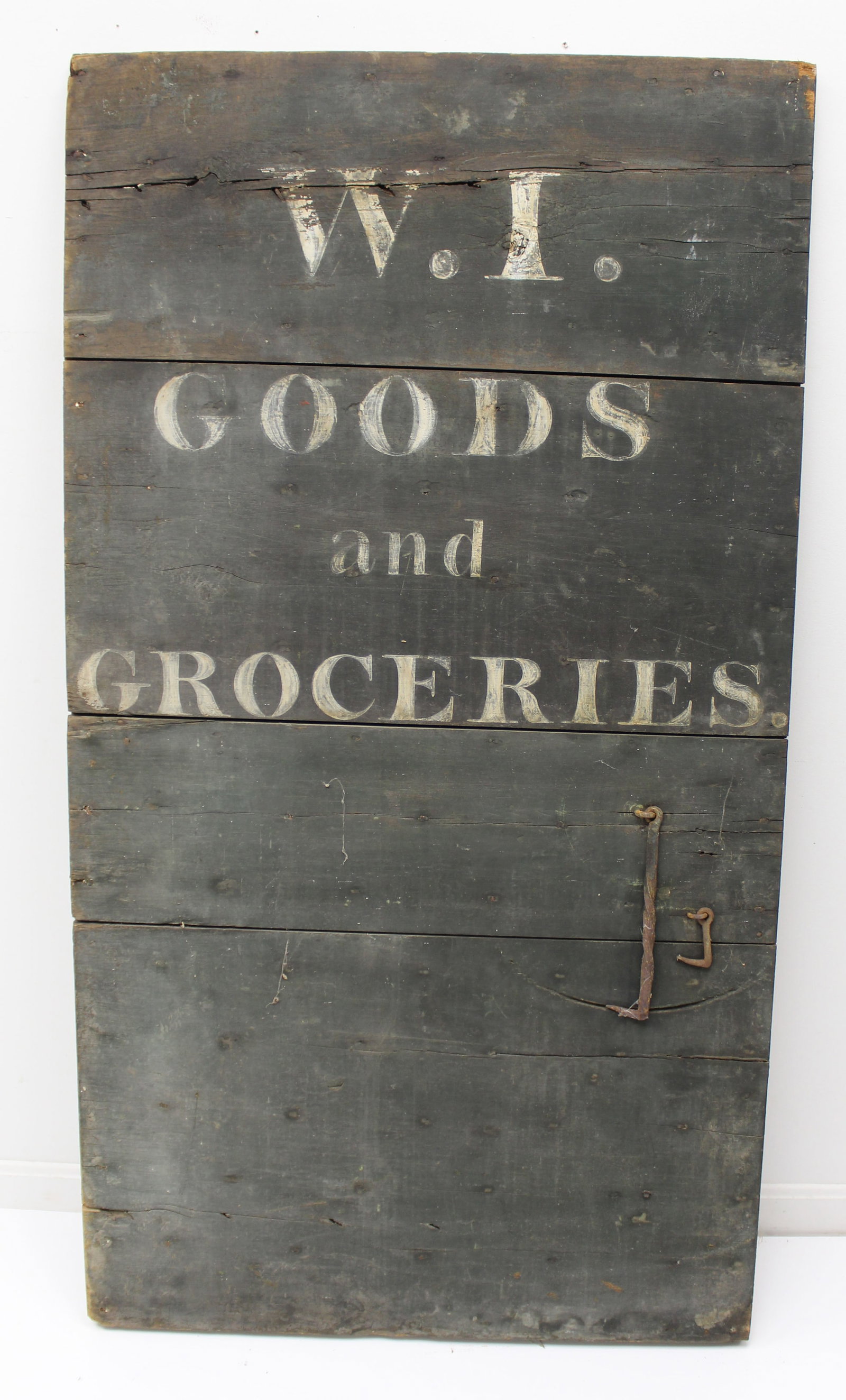 Antique Grocer's sign "W.I. Goods and Groceries" painted on an early wooden door - 60" tall x 32: Antique Grocer's sign "W.I. Goods and Groceries" painted on an early wooden door - 60" tall x 32 1/2" wide