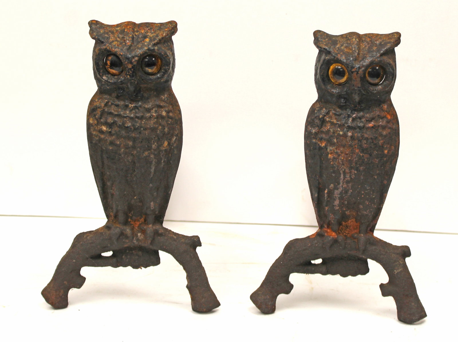 Pair of antique cast iron owl form andirons w glass eyes - 13 1/2" tall: Pair of antique cast iron owl form andirons w glass eyes - 13 1/2" tall