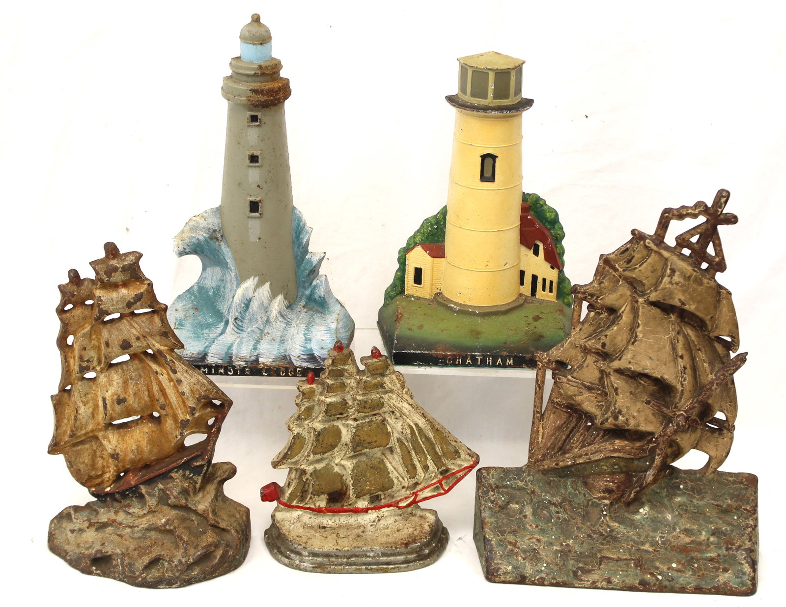 Lot of 5 cast iron painted nautical themed doorstops - lighthouses & ships - 6 1/2" tall - 10" tall (1 of 17)