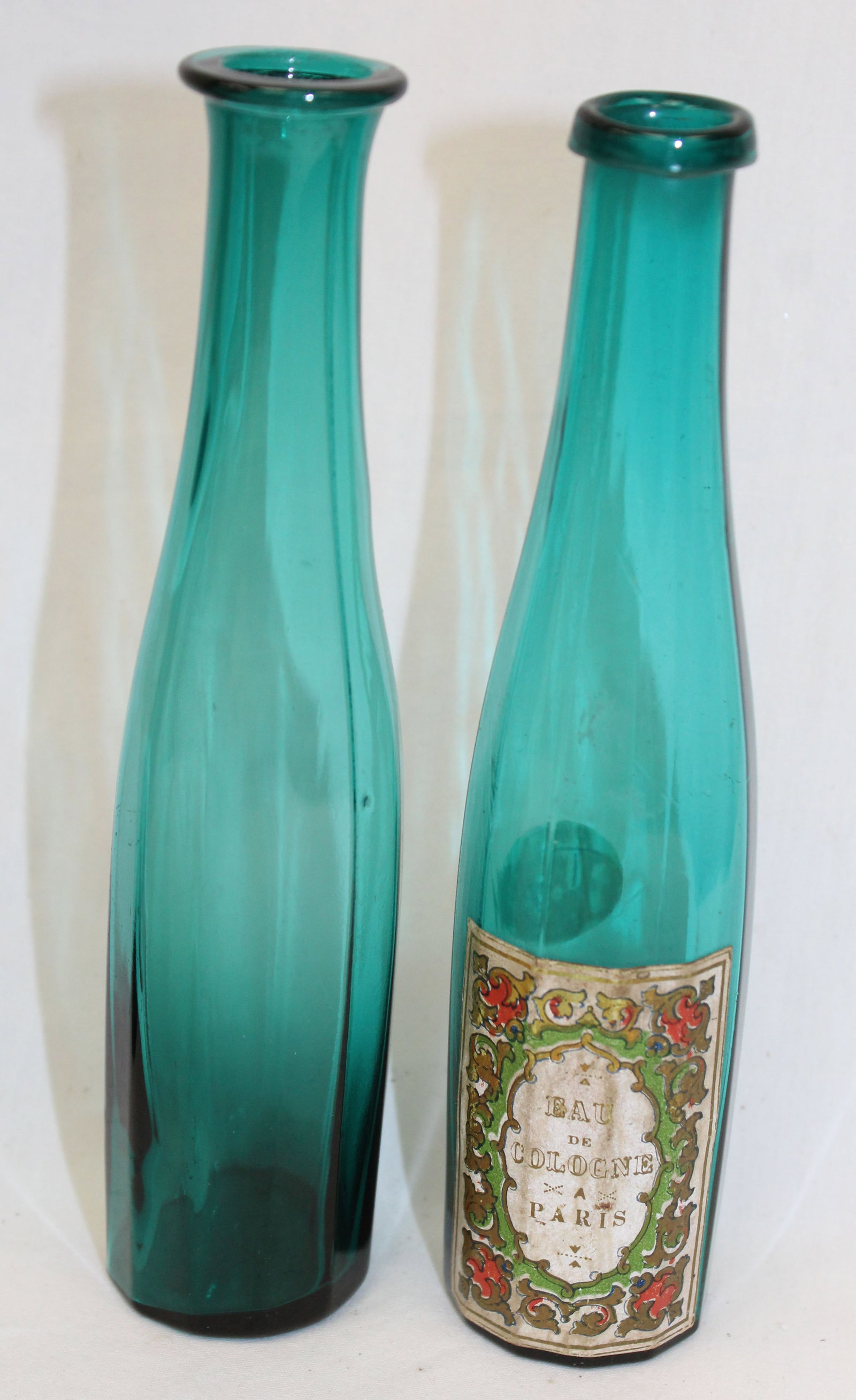 Lot of 2 early teal glass cologne bottles - 1 w partial label - 6 1/2" tall (1 of 5)