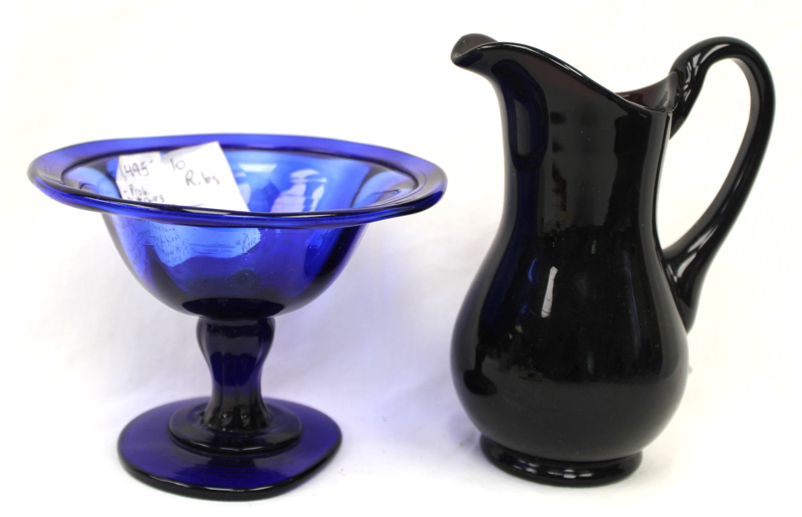 Lot of 2 antique glass items - cobalt compote & rosy amber pitcher - 4 1/4" tall x 5 3/4" diam & 6