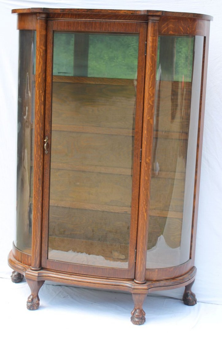 Victorian carved Oak ball & claw foot bow front china: Victorian carved Oak ball & claw foot bow front china cabinet w partial mirror back 62 1/2" tall x 42" wide