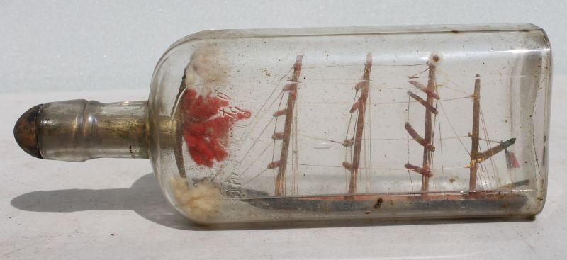ca late 19thC sailor made ship in a bottle - 9" long: ca late 19thC sailor made ship in a bottle - 9" long