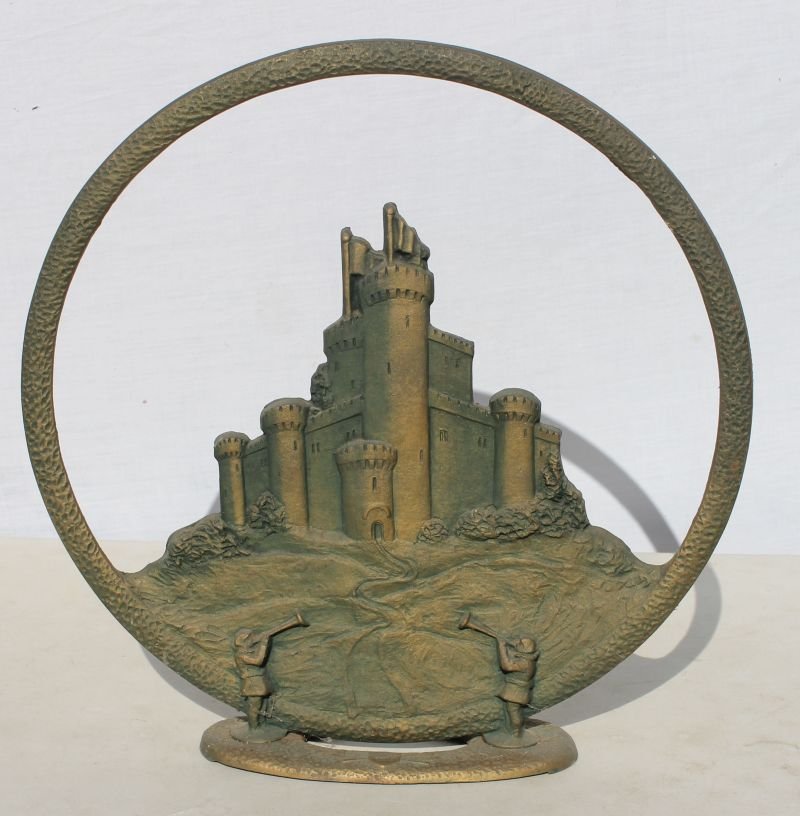 unusual "Towers" iron radio speaker cover depicting: unusual "Towers" iron radio speaker cover depicting encircled multiple castle towers & 2 town criers - Was currently being used in an 18thC built home as a doorstop - 18" diam