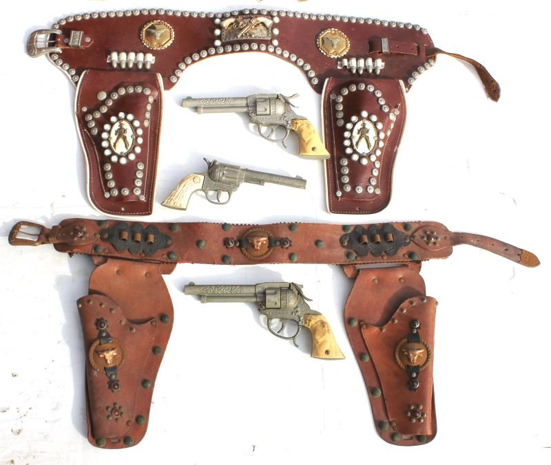 lot of toy gun holsters w 3 guns - 1 marked "Hubley" &: lot of toy gun holsters w 3 guns - 1 marked "Hubley" & 2 marked "Texas" (holsters are quite fancy)