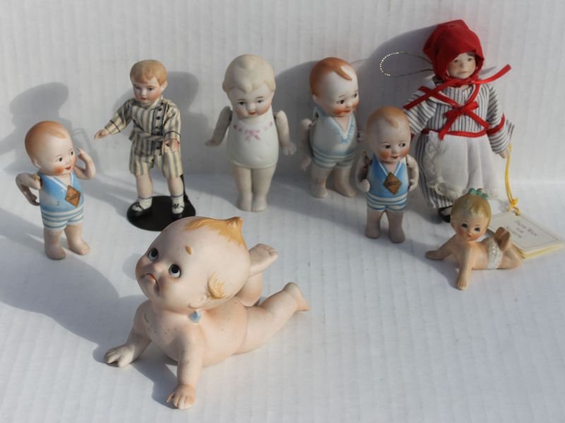 lot of 7 all bisque dolls incl 4 Nippon ca 1920's w: lot of 7 all bisque dolls incl 4 Nippon ca 1920's w jointed arms, Kewpie type piano baby, Faith Wick for Sylvestri, a boy in suit & a nodder (needs restringing)