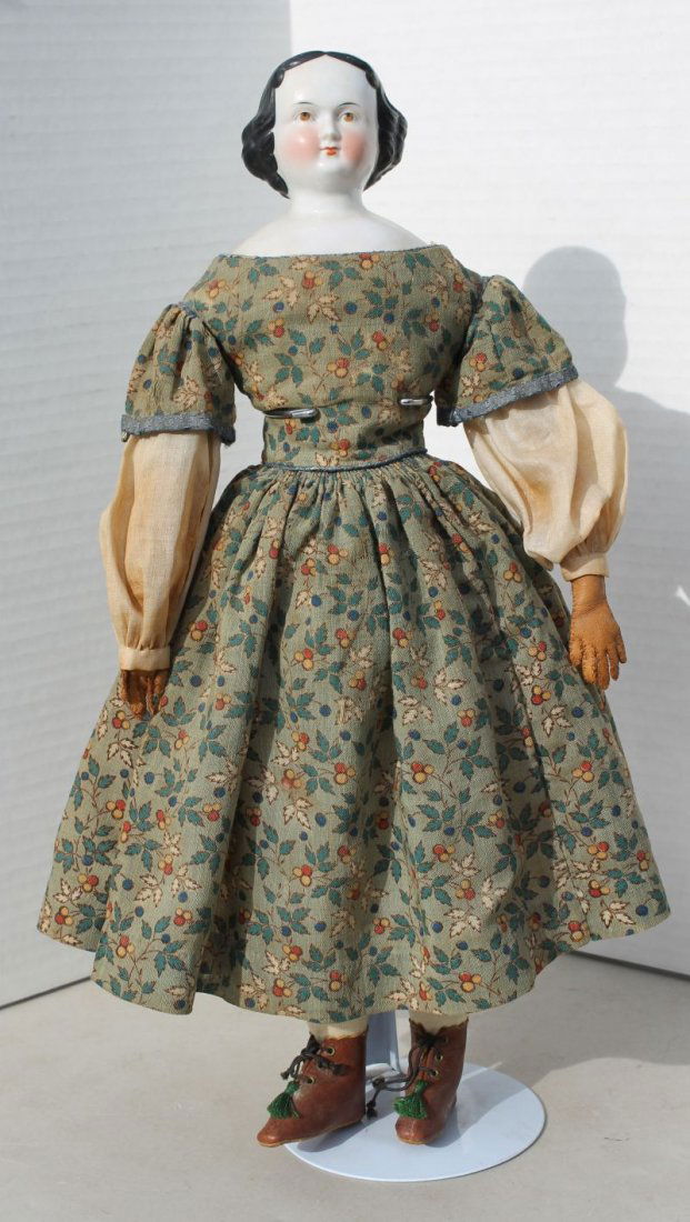 ca 1860-1870 china shoulder head doll on cloth body w: ca 1860-1870 china shoulder head doll on cloth body w leather arms, cloth legs & black flat top style w rare brown eyes, rosy cheeks in appropriate clothing & brown leather boots - 17" tall