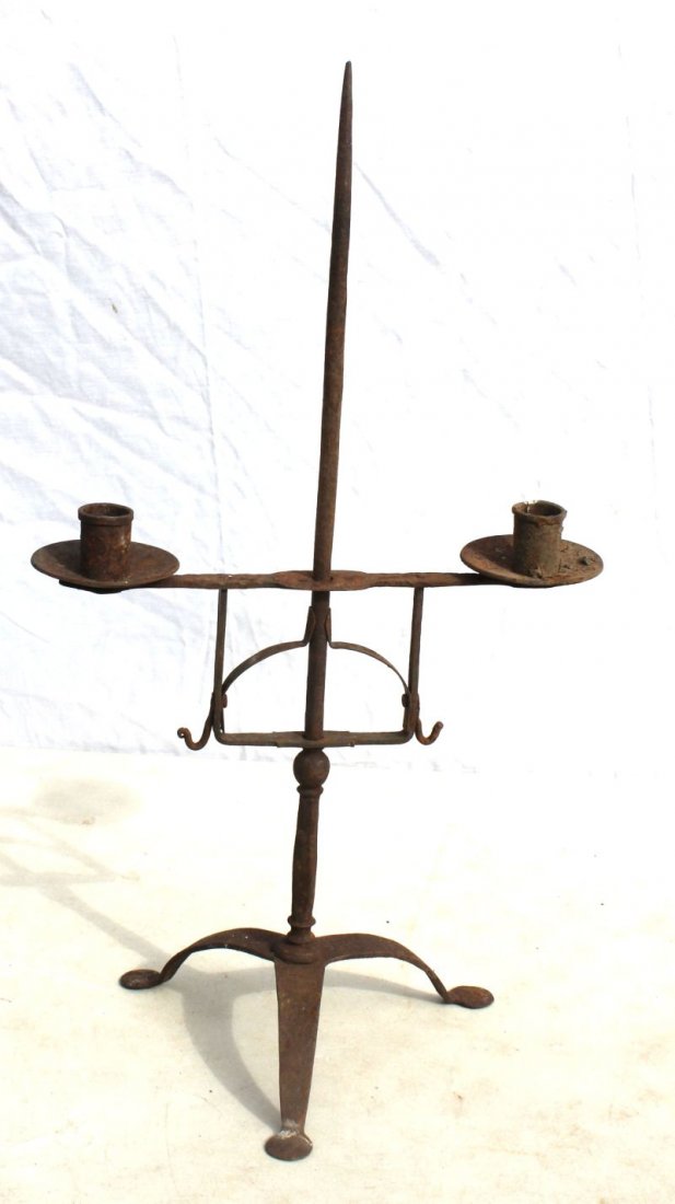 Antique iron adjustable 2 arm candle holder on tripod: Antique iron adjustable 2 arm candle holder on tripod base ending in flattened penny feet - 21" tall x 12" wide