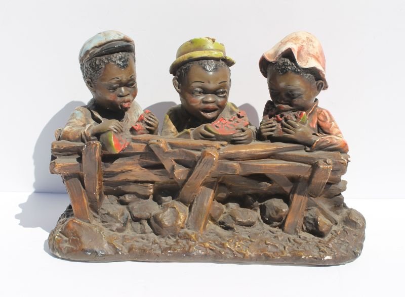 large plaster sculpture of 3 African American boys: large plaster sculpture of 3 African American boys eating watermelon behind a fence - 12" tall x 17" wide