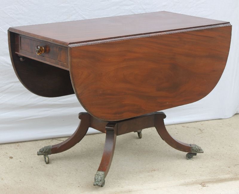 early 19thC period Neoclassical 1 drawer NYC mahog: early 19thC period Neoclassical 1 drawer NYC mahog dropleaf table attrib to the Duncan Phyfe School featuring spiral carved pedestal on 4 legs ending in lion head brass feet & casters - 40 3/4"