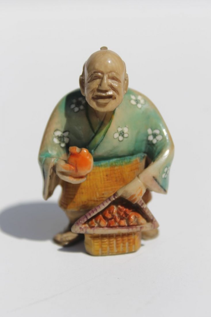 Asian carved painted ivory netsuke of a man w: Asian carved painted ivory netsuke of a man w pomegranites - 2" - sgnd