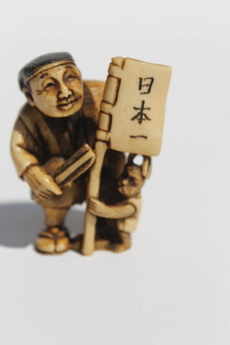 Asian carved ivory netsuke of a man, monkey & flag - 2": Asian carved ivory netsuke of a man, monkey & flag - 2" - sgnd