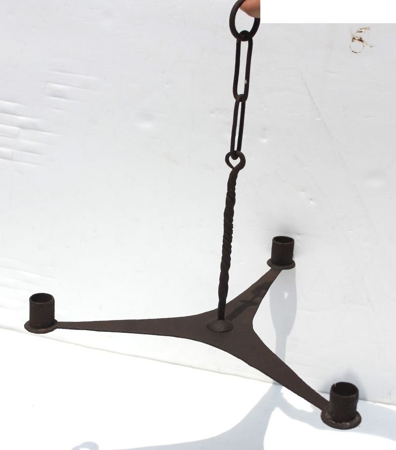 fine and rare mid 18th C american small forged iron: fine and rare mid 18th C american small forged iron chandelier w 3 tapering shaped arms forged from a single piece w lollipop ends. Note: Twisted shaft pig tail ended hanging rod w attached forged iro