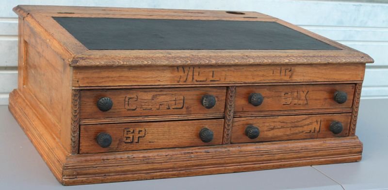 Victorian carved oak "Willimantic" slant lid desk top: Victorian carved oak "Willimantic" slant lid desk top spool cabinet - 30" wide x 23" deep x 12" tall