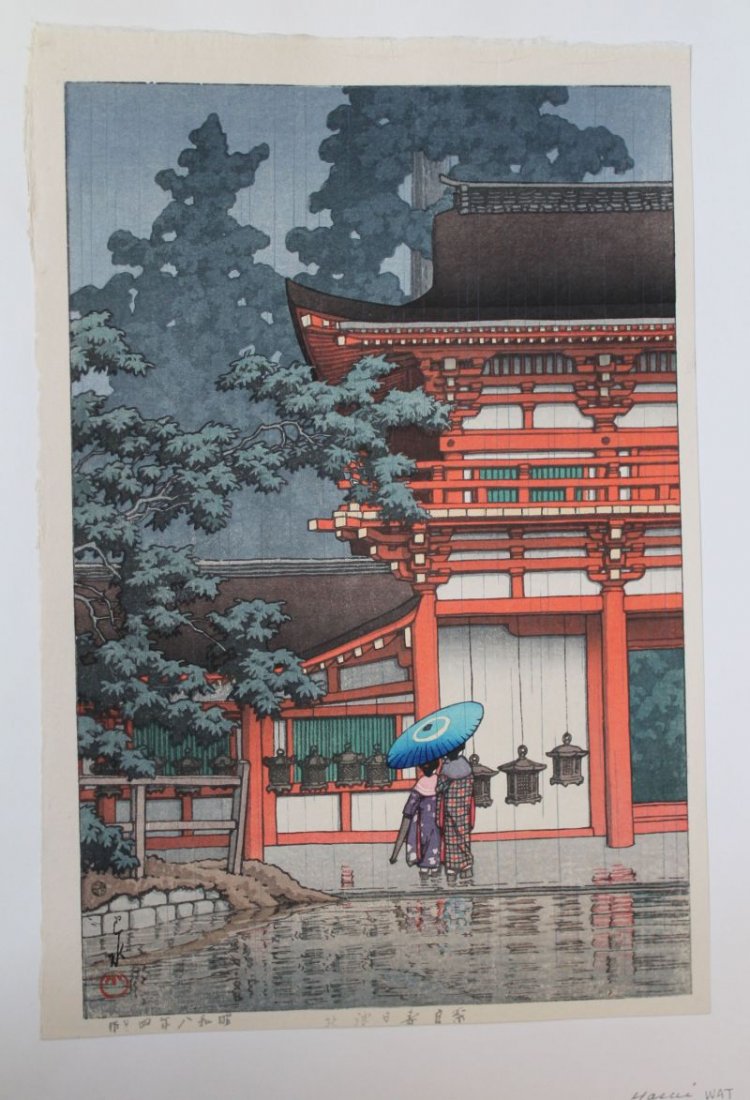 Japanese woodblock print by Hasui rain storm scene w: Japanese woodblock print by Hasui rain storm scene w figures under an umbrella walking near a Temple - 15 1/4" x 10 1/4"