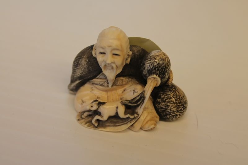 Asian carved ivory netsuke of an elderly man pouring: Asian carved ivory netsuke of an elderly man pouring sand out of a bottle w miniature horse - approx 1 1/4" tall