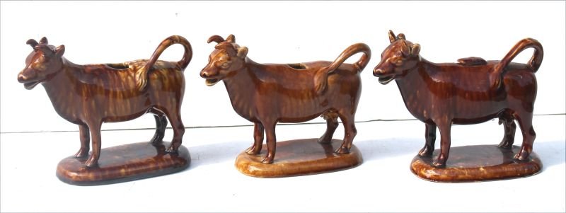 lot of 3 Rockingham/Bennington cow creamers on bases - (1 of 5)