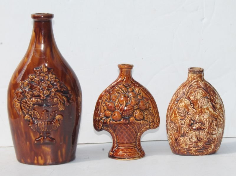 lot of 3 Rockingham bottle flasks - 10 1/2" w urn of: lot of 3 Rockingham bottle flasks - 10 1/2" w urn of flowers dec, a 6 1/2" basket of fruit motif & a 6 1/4" tavern scene w arch of hops - Magdefrau estate