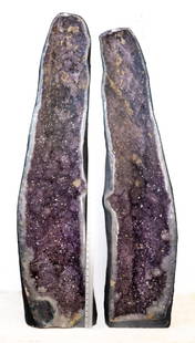 Massive 350LB Amethyst Cathedral Geode Pair: Matching, magnificent amethyst cathedral geode pair. Stunning fluorescent calcite deposits. 53"H, 12"W, 9.5"D and 51"H, 12"W, 9"D, respectively. Includes custom wooden crate for shipping/transportatio