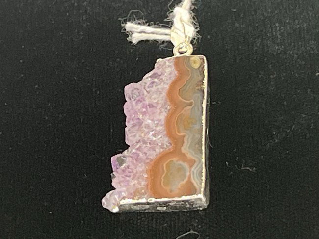 Amethyst Cross-Section Pendant: Amethyst cross-section pendant with silver-colored plating on edges.