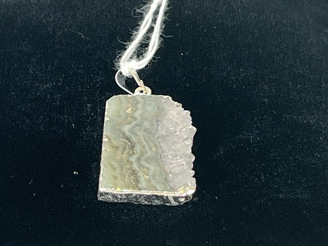 Amethyst Cross-Section Pendant: Amethyst cross-section pendant with silver-colored plating on edges.
