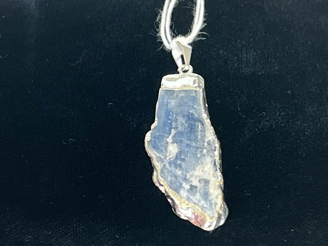 Blue Kyanite Pendant: Blue kyanite pendant with silver-colored plating on edges.
