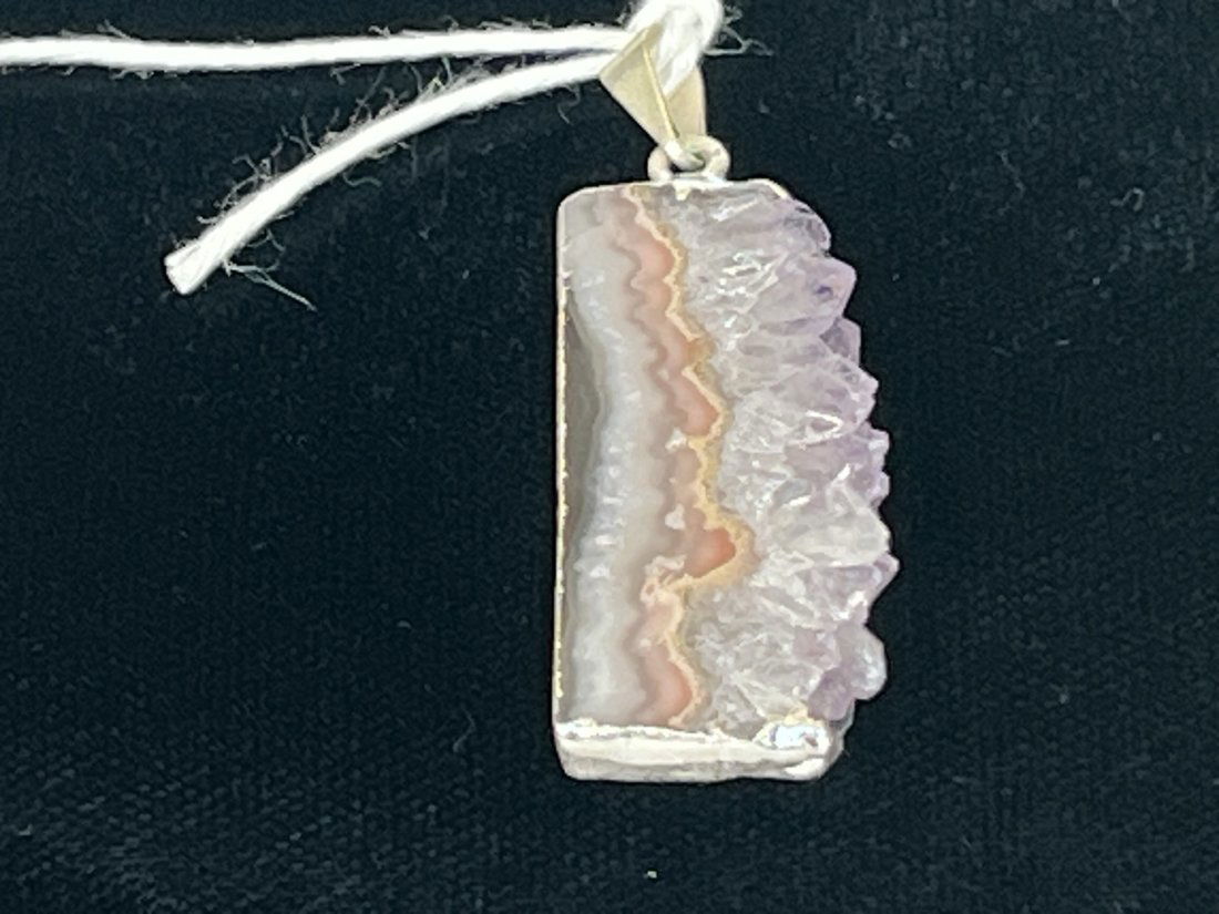 Amethyst Cross-section Pendant: Amethyst cross-section pendant with silver-colored plating on edges.