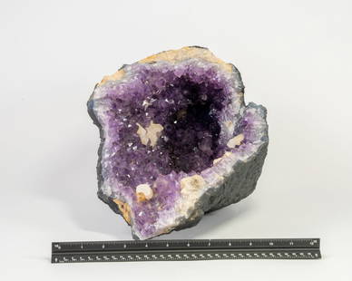 Large Amethyst Vug Geode with Fluorescent Calcite Crystals: Twenty-seven pound amethyst vug geode with fluorescent calcite inclusions. 8" x 16" x 8".