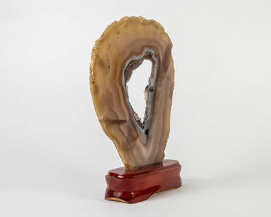 Polished Agate Slice on Wood Stand: Polished agate slice on wood stand. 9" x 7.75" x 2". 2.2 pounds.