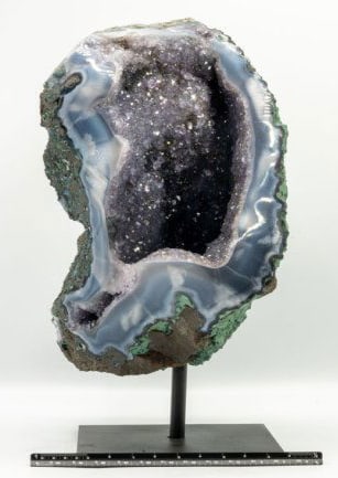 Amethyst and Agate Geode with Goethite and Magnetite on Stand: Amethyst and agate geode with goethite and magnetite with polished edges on black metal stand. 10.5" x 6" x 6". 12 pounds, 6 ounces.
