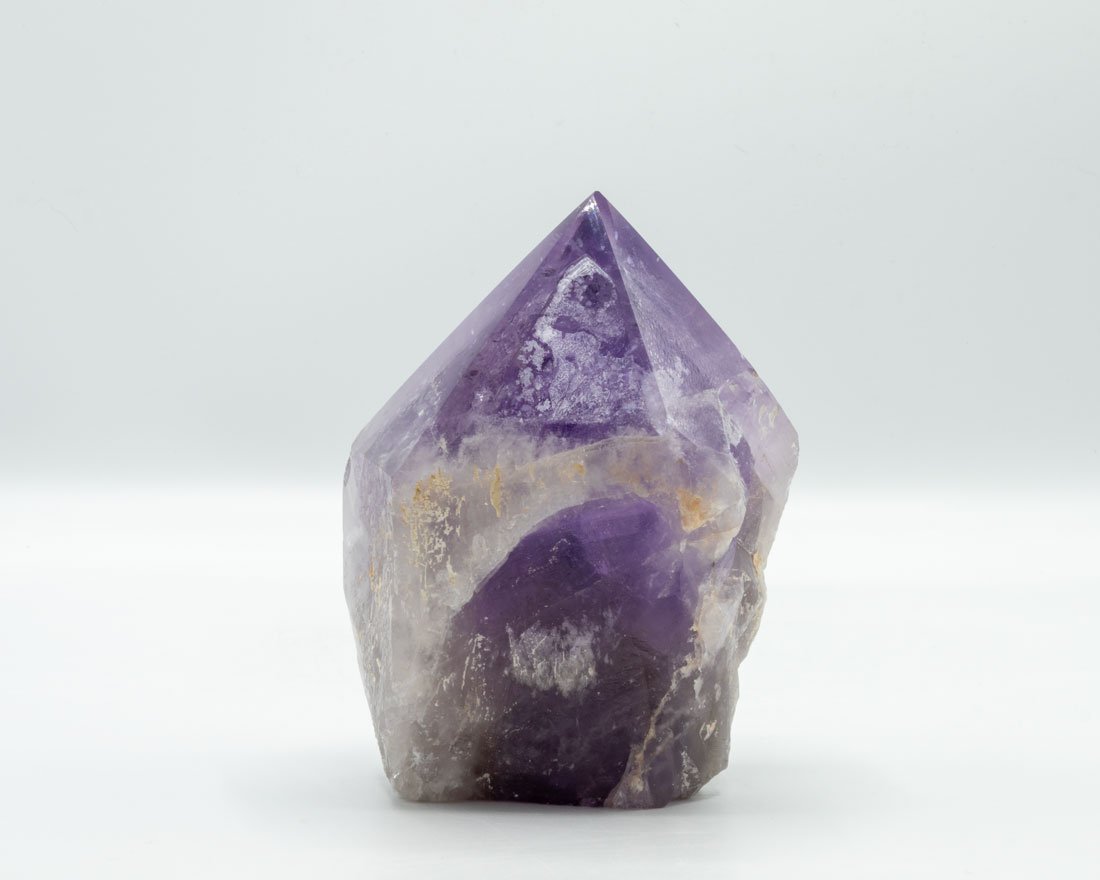 Single Amethyst Crystal Point: Single amethyst crystal point with great color and outstanding inclusions.. 4.25" x 3.5" x 3". 1 pounds, 11 ounces.