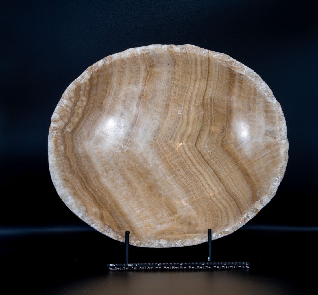 Large Carved Mexican Onyx Bowl: Large, carved and polished Mexican onyx bowl with an unpolished rim. A great table centerpiece. 12" x 10" x 2.25". 9 pounds, 6 ounces.