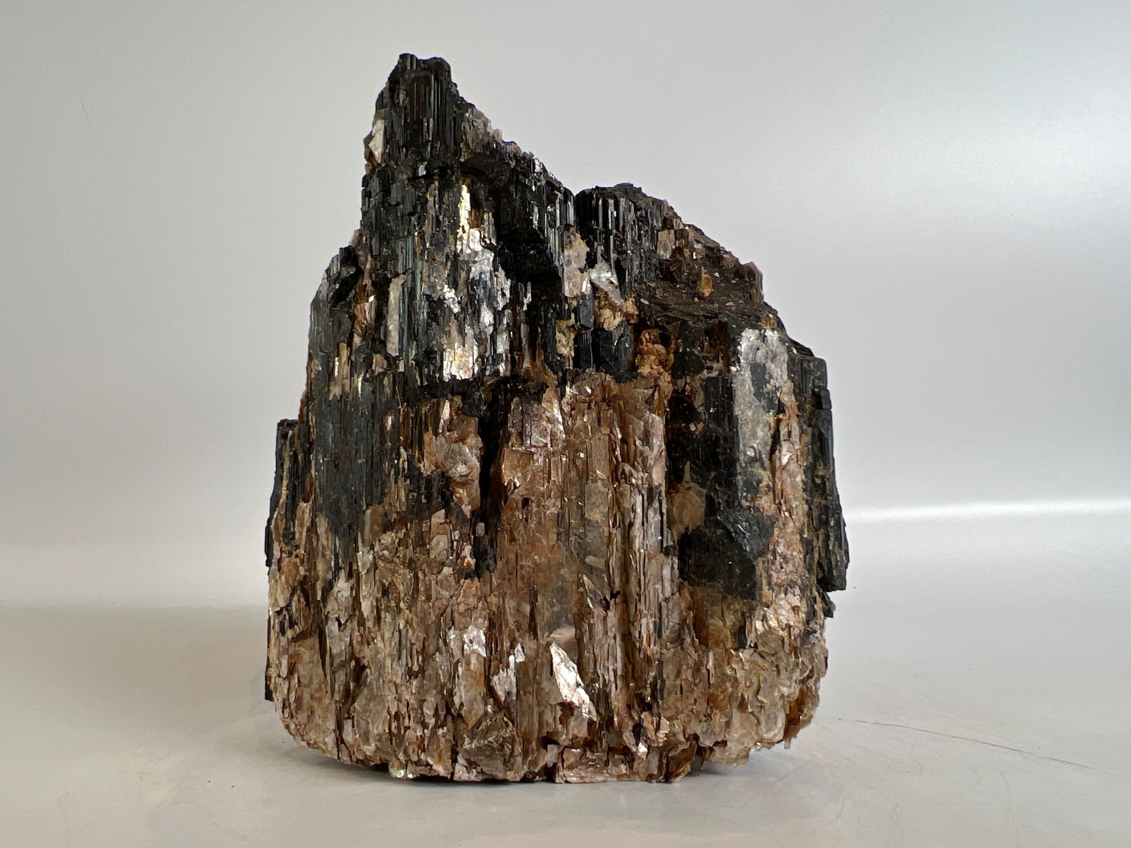 Black Tourmaline and Golden Mica Formation: Black tourmaline and golden mica formation. 5" x 4.5" x 2.5". 2 pounds, 10 ounces.
